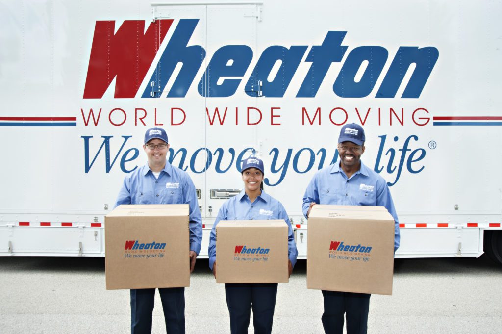 Three Olympic Movers in front of a Wheaton moving truck