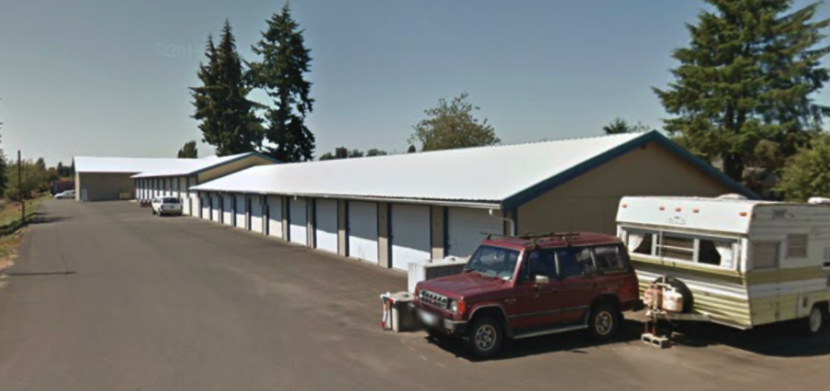 Self storage facility in Elma WA with several units and a car and trailer to the side of the units