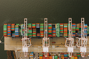 A massive container ship sailing on the ocean, representing international moving services provided by a Tacoma moving company.