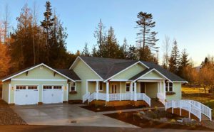 A cozy Olympic Peninsula home with a garage and driveway, demonstrating how to find the perfect home in the Olympic Peninsula.