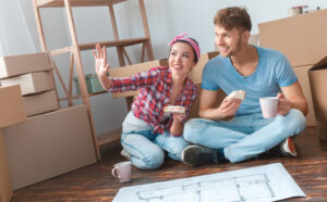 A couple organizing their new Washington home amidst moving boxes and papers during a winter reorganization project, demonstrating how to tackle a winter reorganization project in your home.