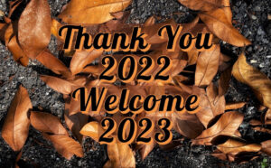 "Thank you 2022, welcome 2023!", on a background of fall leaves, as Olympic Moving & Storage celebrates a successful year with gratitude and anticipation.