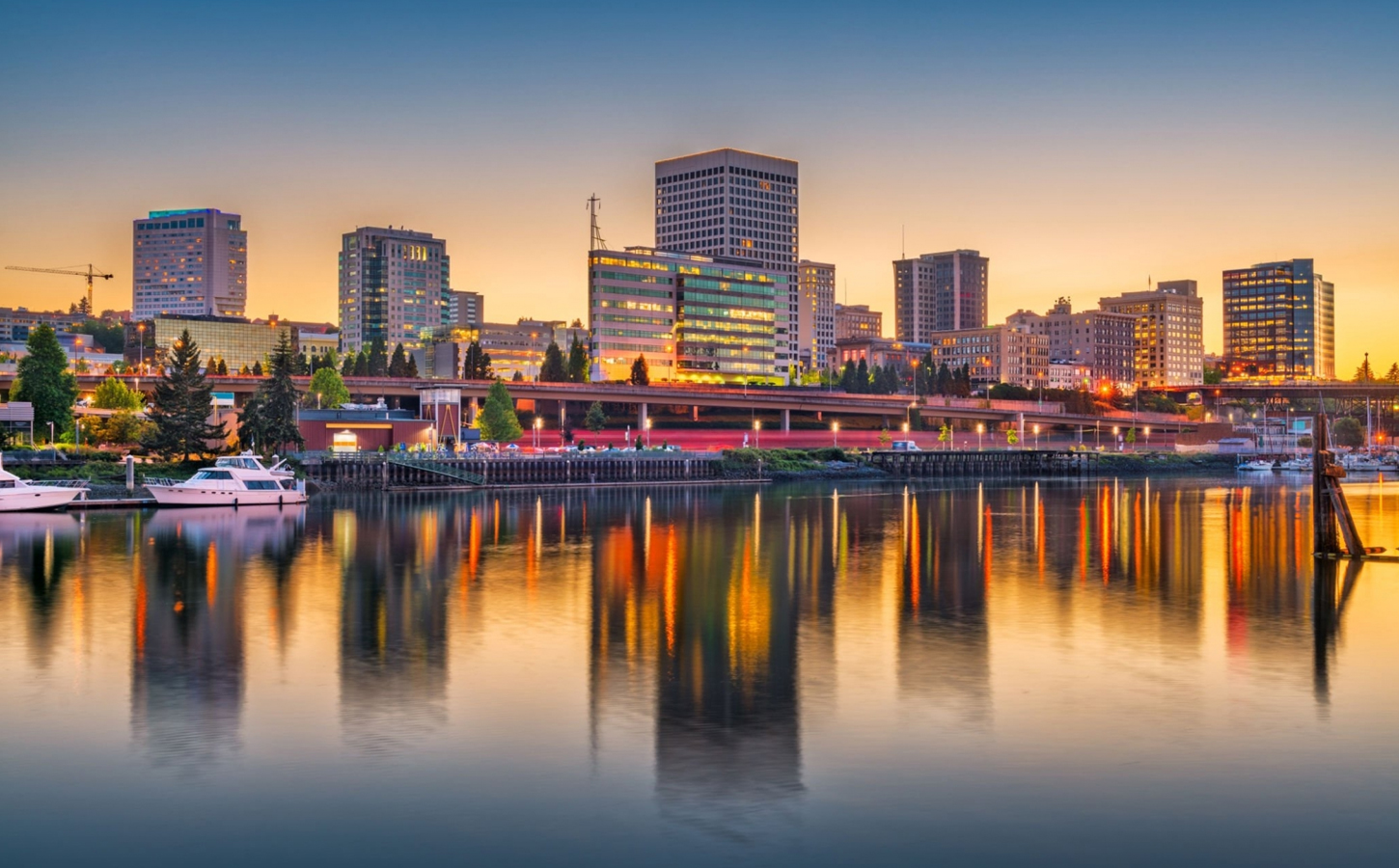 A stunning sunset over Tacoma, Washington, USA, with a beautiful cityscape reflecting on the water, demonstrating the complete guide to moving to Tacoma.