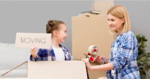 A woman and a girl moving boxes together while moving to Olympia, demonstrating the top reasons to move to Olympia in 2023.