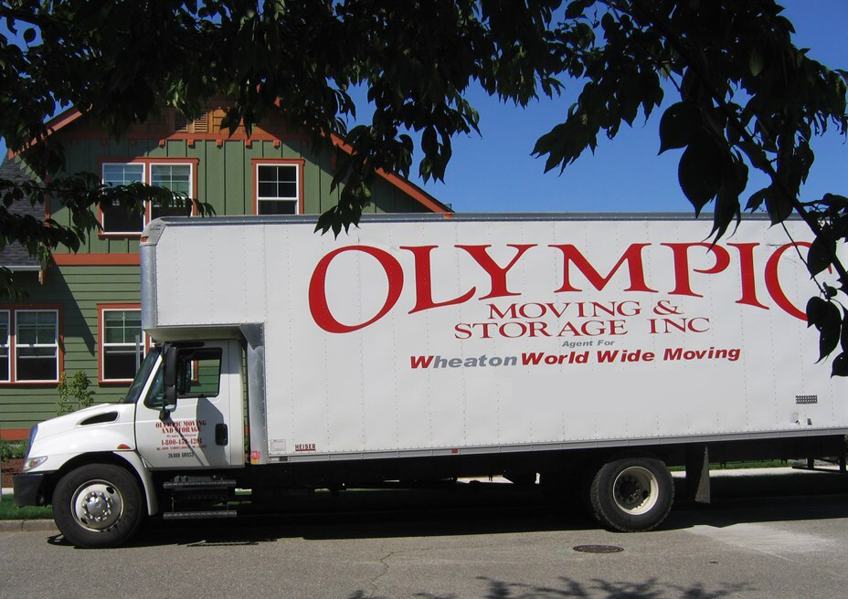 A parked Olympic Moving & Storage truck in front of a house in Tumwater, WA. A Tumwater, WA moving company.